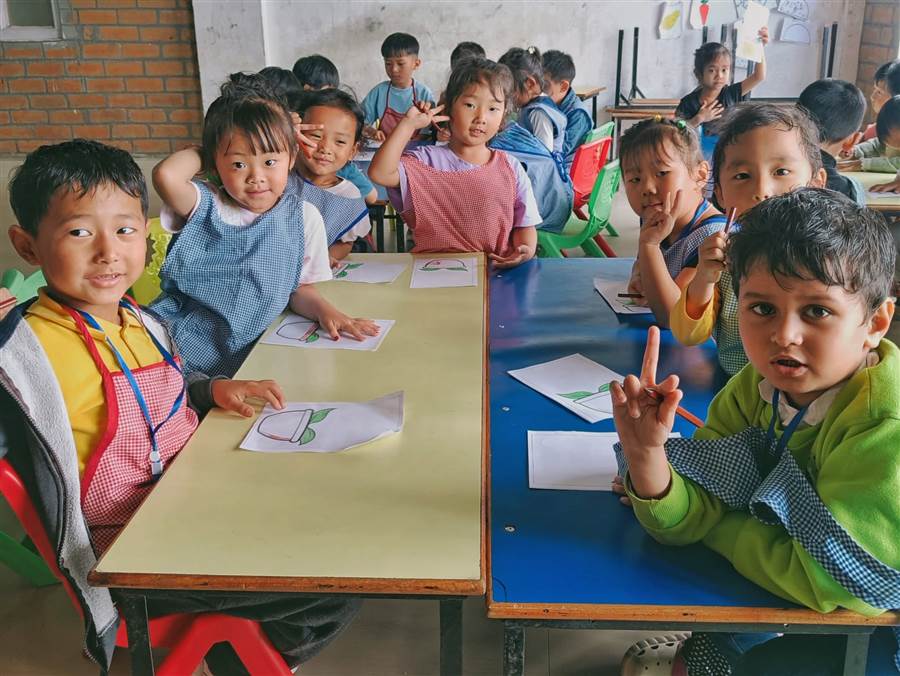 Young learners at their desks during an activity class