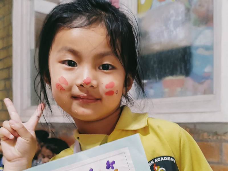 A student showing her finished artwork